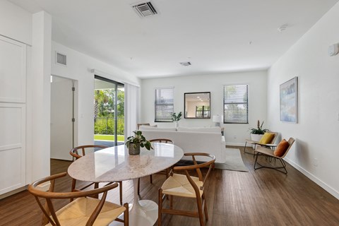 a living room with a white couch and a table and chairs